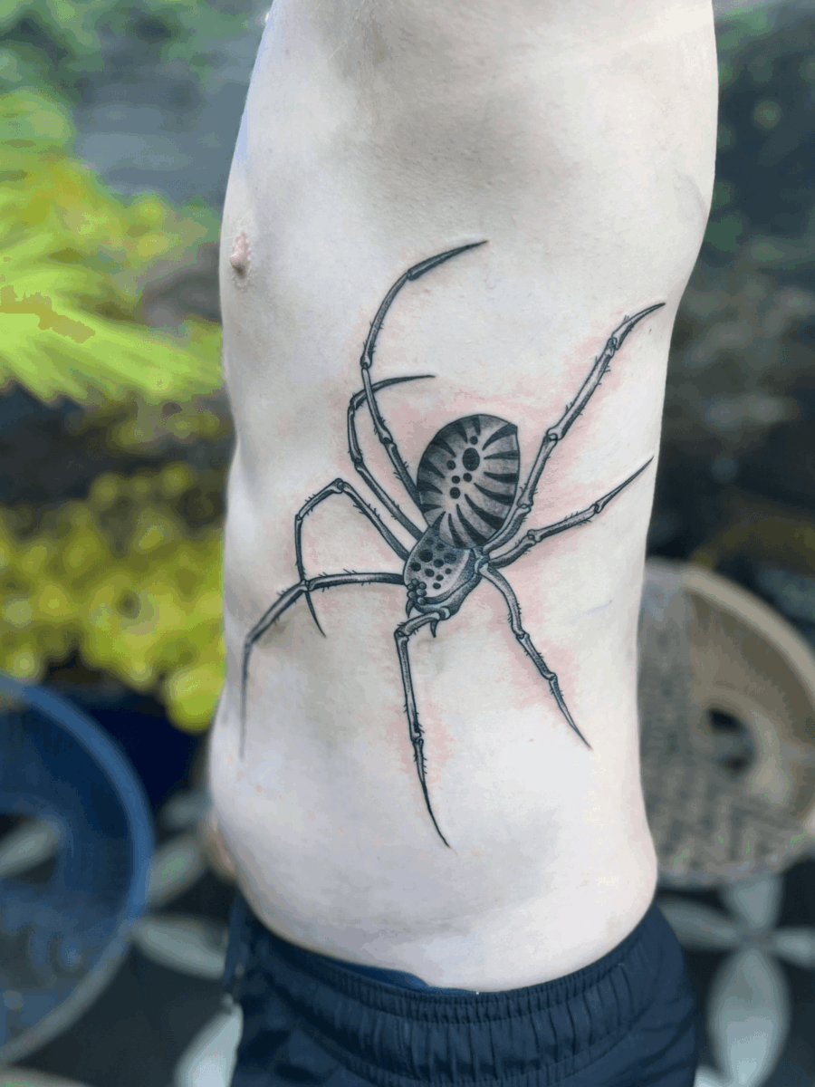 large spider tattoo on ribs at Storyville Tattoo Studio London